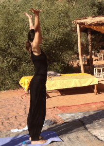 Anica practicing yoga tree pose in desert camp Morocco_Source NOSADE