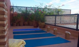 Marrakech rooftop Yoga_Source Amanda LaMagna Livaligned